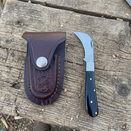 Billhawk pocket knife with black plastic handle and leather sheath