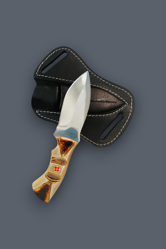 A fixed-blade knife with a polished silver blade and a marbled beige and brown handle, shown in front of a black leather sheath with white stitching, on a solid dark gray background.