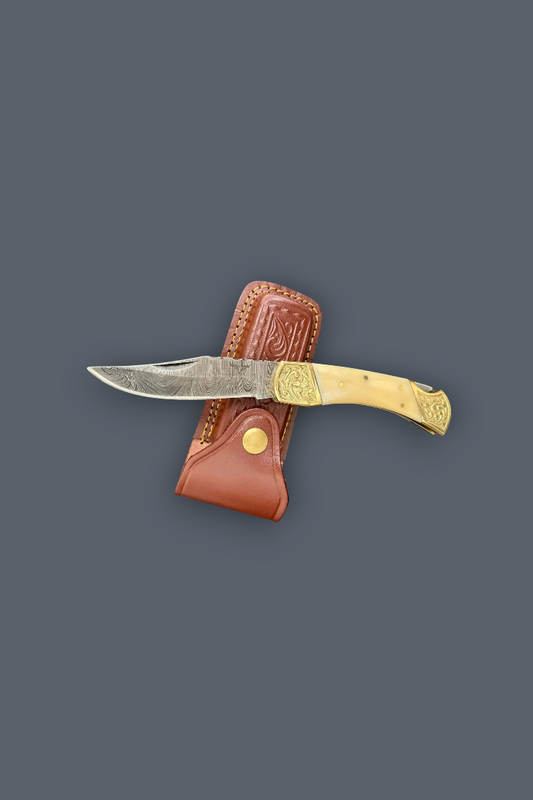 A folding pocket knife with a silver steel blade, a light tan bone handle, and a brown leather sheath, displayed against a solid dark gray background.