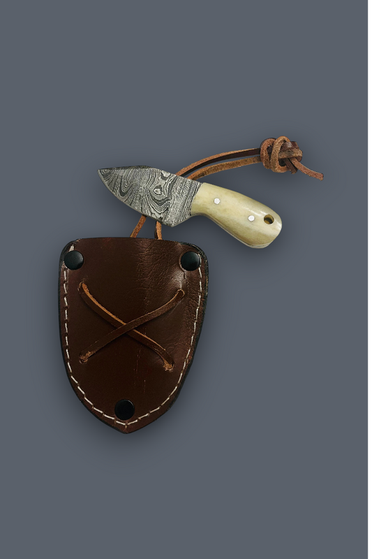 A fixed-blade knife with a patterned steel blade, cream bone handle, and brown leather sheath, displayed on a solid dark gray background.