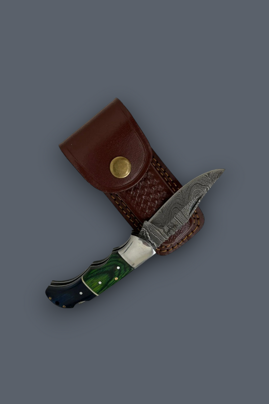 A fixed-blade knife with a patterned steel blade, green and black handle, and a brown leather sheath, displayed on a solid dark gray background.