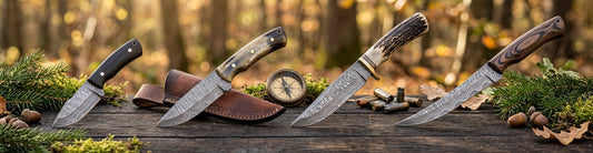 Ultra-wide banner displaying four different handcrafted Damascus hunting knives lined up side-by-side against a clean background.