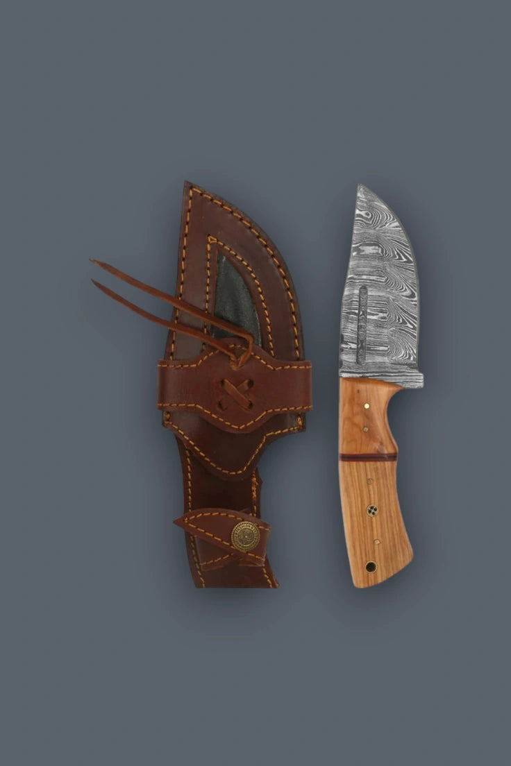 Top-down view of the 4-inch Damascus fixed blade hunting knife and cowhide leather sheath, serving as durable EDC gear.