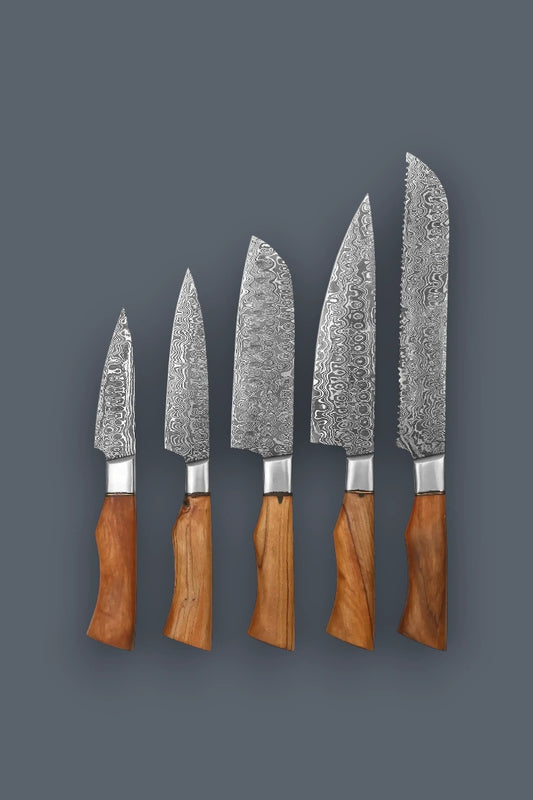 Vertical flat lay showcasing the premium 5-piece Damascus steel kitchen knife set, featuring varied hand-forged blades and contoured wood handles.