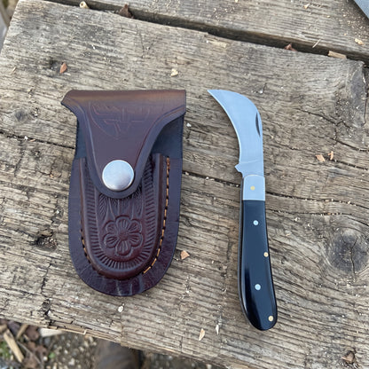Billhawk pocket knife with black plastic handle and leather sheath

