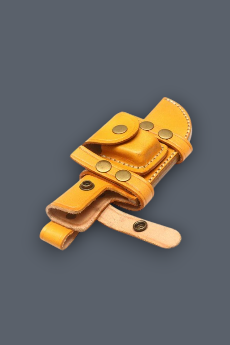 A light tan leather knife sheath with brass-colored metal snaps, shown on a solid dark gray background.