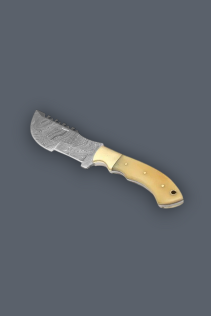 A fixed-blade knife with a patterned steel blade and a light beige handle, shown on a solid dark gray background.