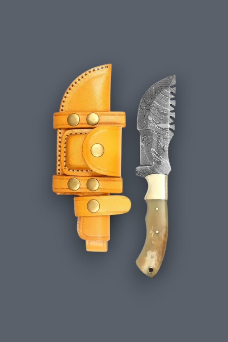 A fixed-blade knife with a patterned steel blade, cream handle, and bone bolsters, displayed next to its bright yellow leather sheath with brass snaps on a dark gray background.