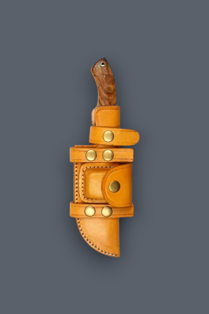 A tan leather knife sheath holding a knife with a dark wood handle, shown against a solid dark gray background.
