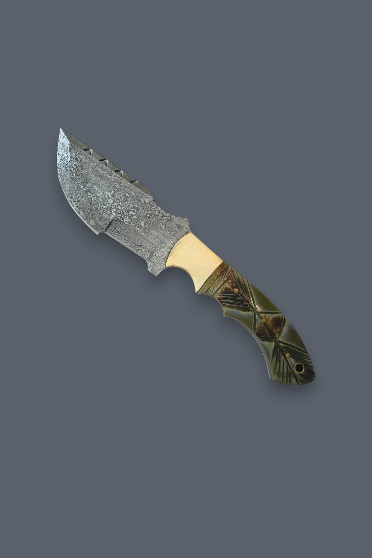 A custom fixed-blade knife with a patterned steel blade, a brass bolster, and a dark green and gold geometric inlay handle, shown against a solid dark gray background.