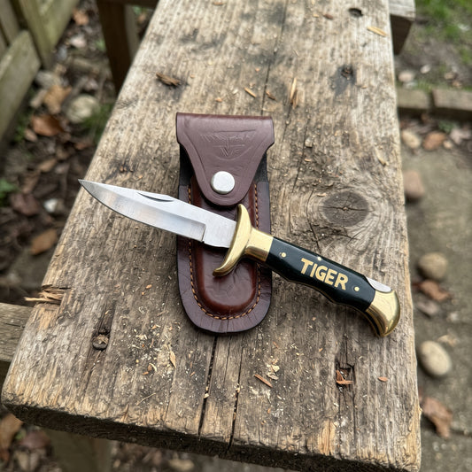 "Tiger" Stainless Steel Folding Pocket Knife — Clip Point Blade, Black Plastic Handle, Double Brass Finger Guard, with Leather Sheath