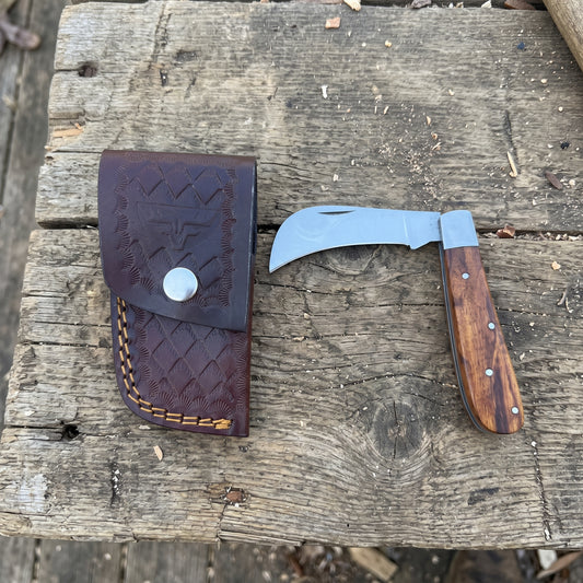 Hawkbill pocket knife with brown wood handle and genuine cowhide leather sheath

