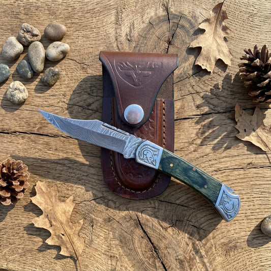 Patterned folding pocket knife with black pakkawood handle and leather sheath