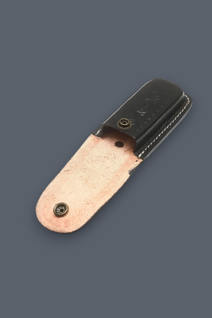 A small leather sheath with a black top section and a light tan underside, shown on a plain dark gray background.