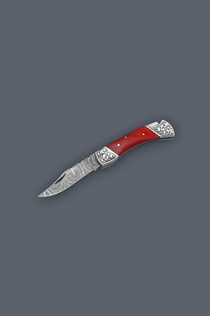A folding pocket knife with a red handle and patterned steel blade, shown diagonally on a solid dark gray background.