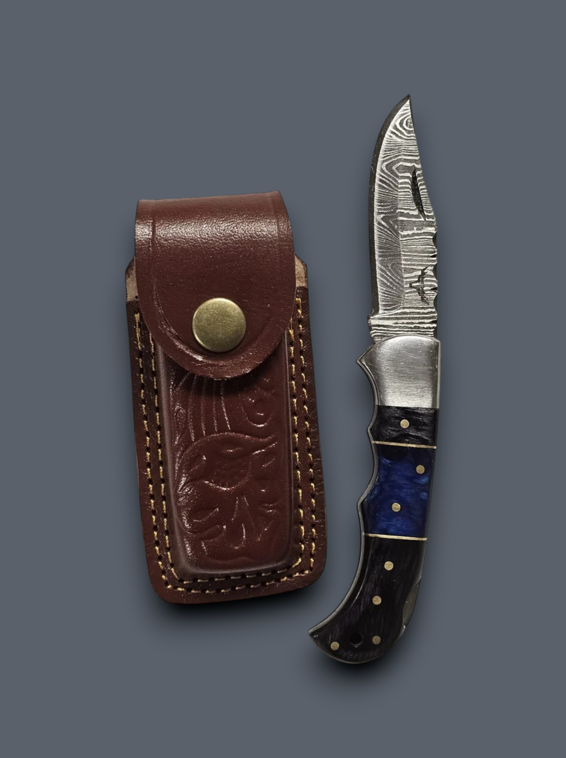 Custom Damascus folding knife featuring a blue wood handle and handcrafted leather belt sheath