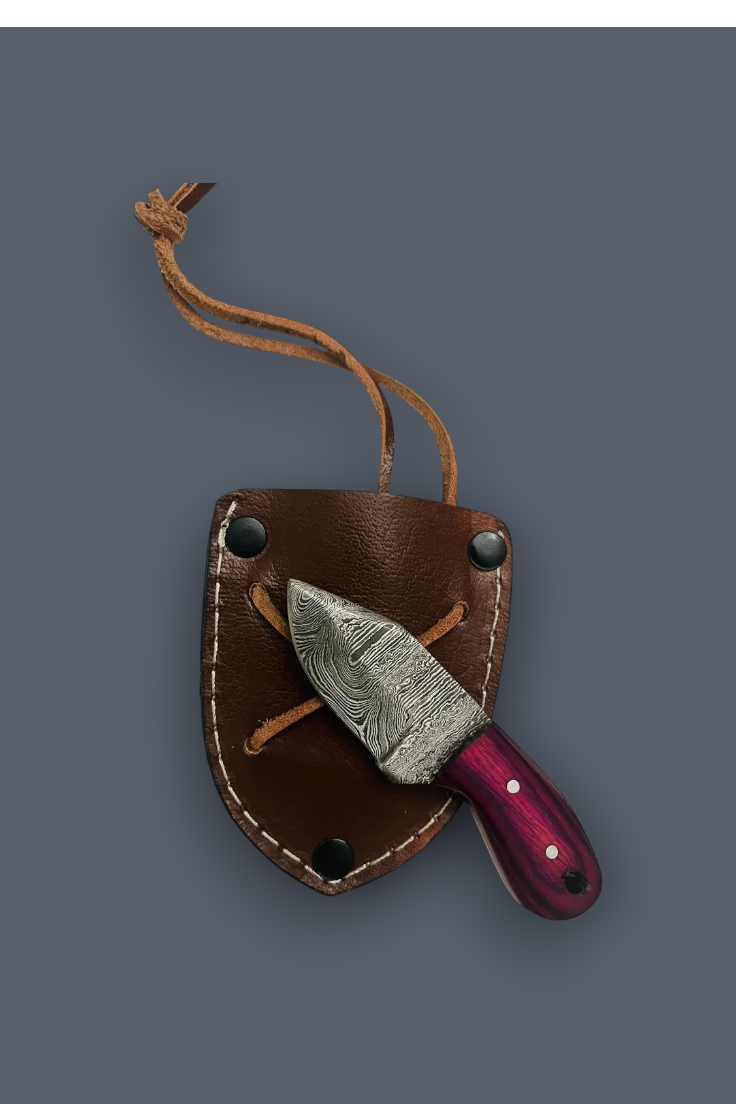 A fixed-blade knife with a patterned steel blade and a dark purple handle, tucked inside a brown leather sheath with a matching lanyard, set against a solid dark gray background.