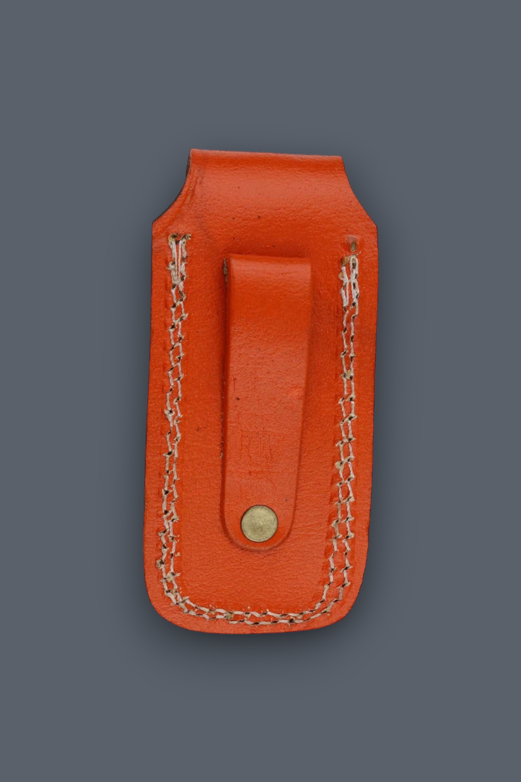 An orange leather money clip with a snap button closure and decorative chain stitching, shown against a solid dark gray background.