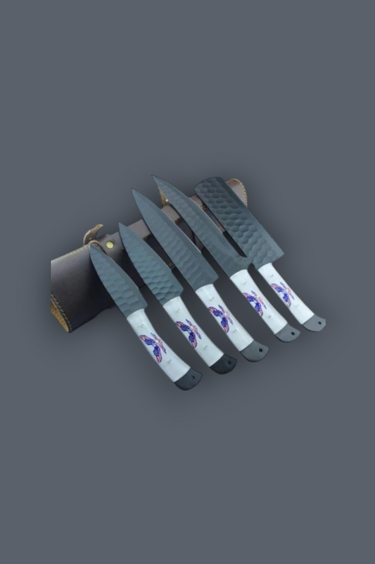 A set of five knives with textured gray blades and white handles featuring purple and blue graphic designs, displayed next to a dark leather sheath on a solid dark gray background.