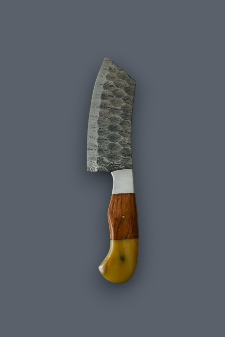A kitchen knife with a hammered Damascus steel blade, a silver bolster, and a dual-tone wooden handle with a yellow inlay, shown against a solid dark gray background.