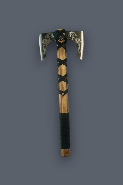 A Viking-style double-bitted axe with a wooden handle, black leather-wrapped sections, and silver steel blades featuring engraved Norse animal motifs, shown against a solid dark gray background.