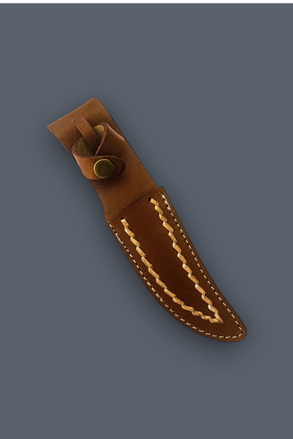 A brown leather knife sheath with decorative contrast stitching and a brass snap closure, shown diagonally on a solid dark gray background.