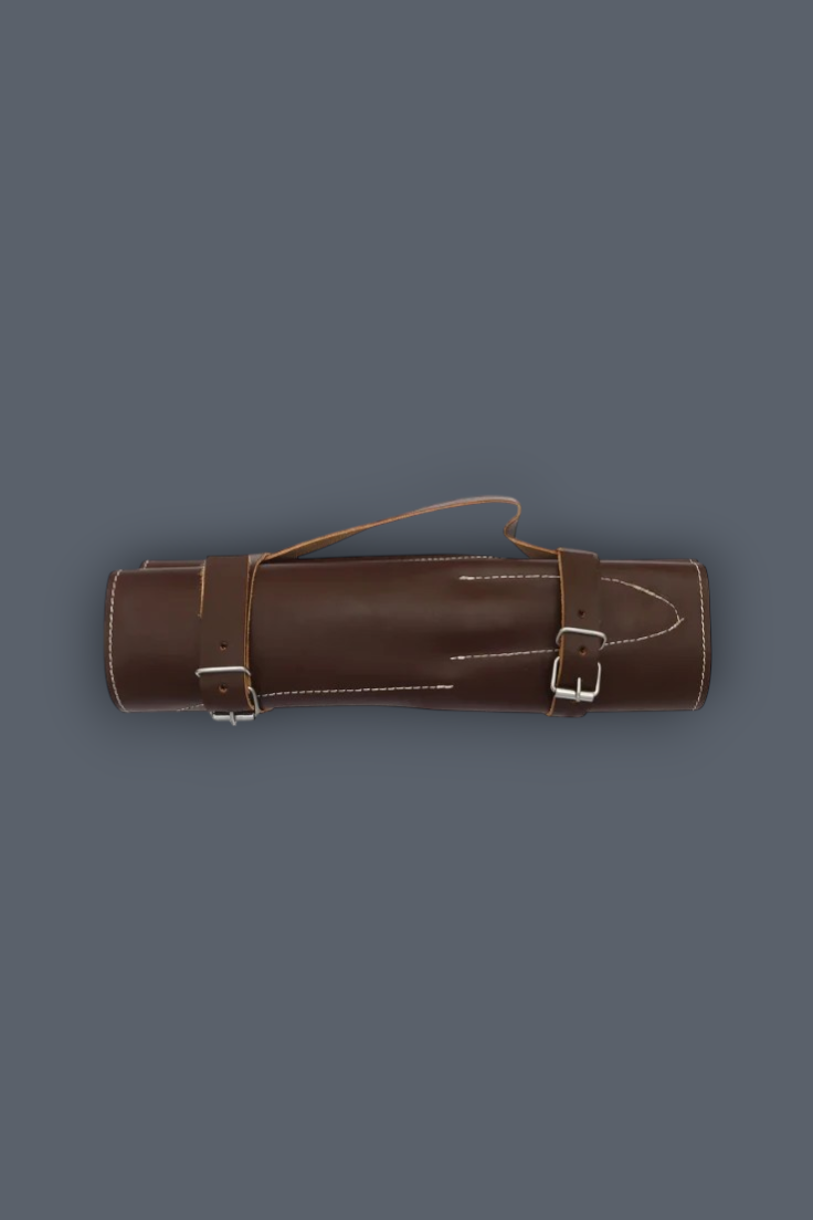 A brown leather cylindrical case with two buckle straps and a top loop handle, shown against a solid dark gray background.