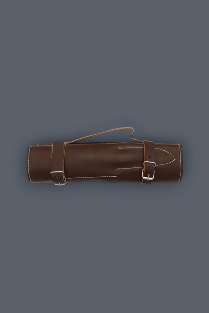 A brown leather cylindrical case with two buckle straps and a top loop handle, shown against a solid dark gray background.