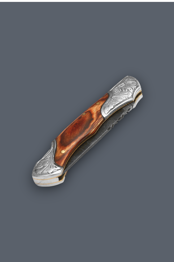A folding pocket knife with a polished brown wood handle and ornate silver-toned metal guard and bolster, shown on a solid dark gray background.