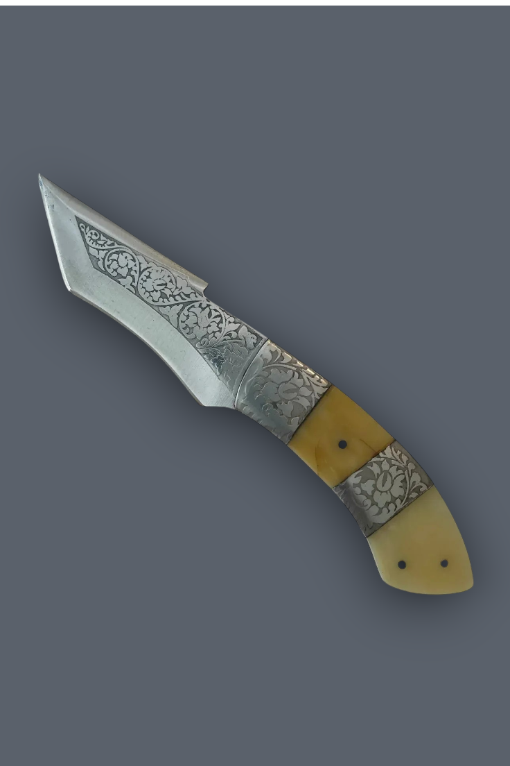 A decorative folding pocket knife with a patterned steel blade and a handle made of yellow bone and patterned silver inlays, shown on a solid dark gray background.