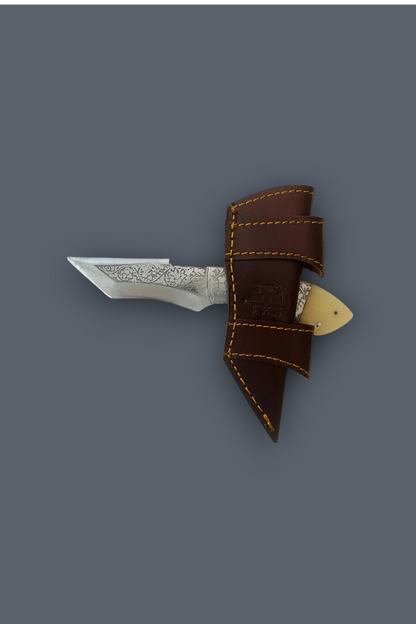 A small fixed-blade knife with a patterned silver blade, shown partially tucked into a brown leather sheath with yellow stitching, against a solid dark gray background.