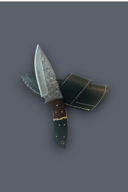 A fixed-blade knife with a patterned steel blade, dark brown handle, and green handle, shown crossed with its black leather sheath on a solid dark gray background.