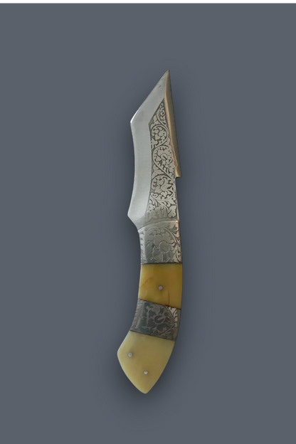 A decorative folding pocket knife with an engraved steel blade, a silver-toned bolster, and a handle made of alternating cream bone and patterned steel inlays, shown against a solid dark gray background.