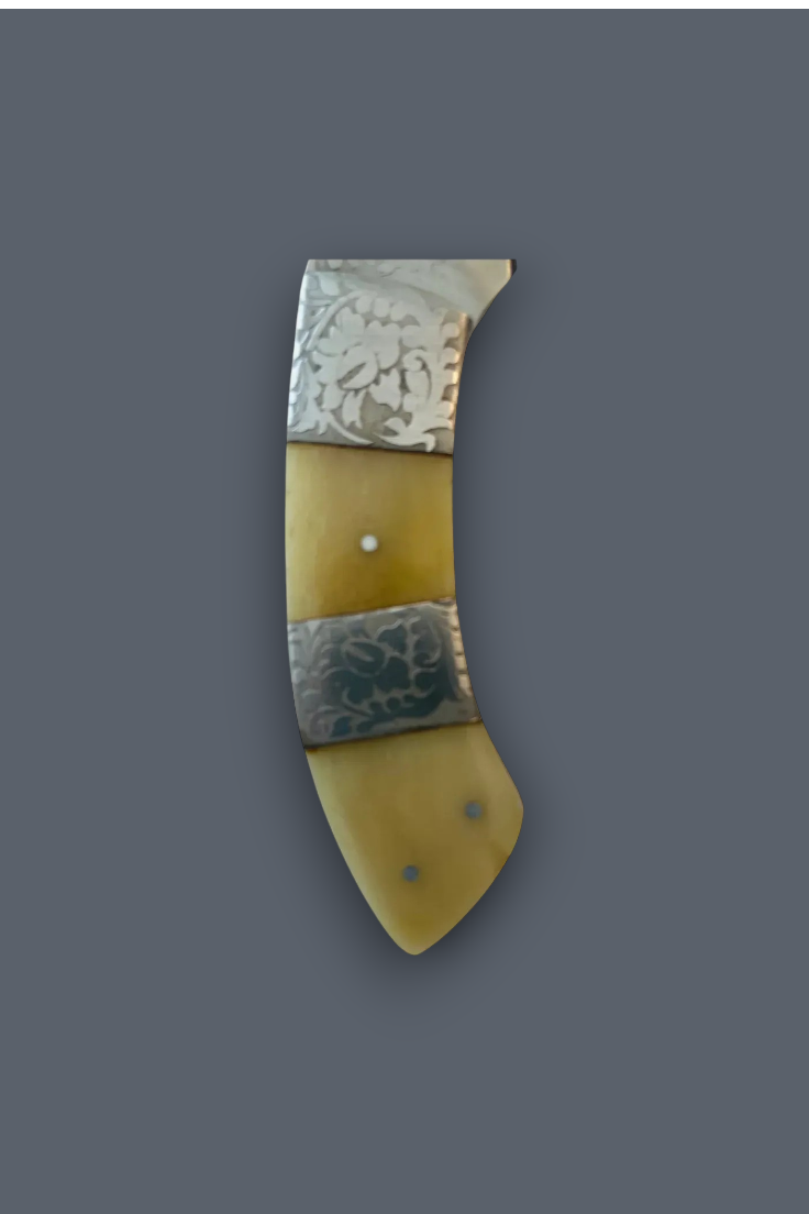 A vintage-style curved knife or tool handle made of pale yellow bone or horn with two silver-toned metal bands featuring engraved floral or leaf patterns, shown on a solid dark gray background.