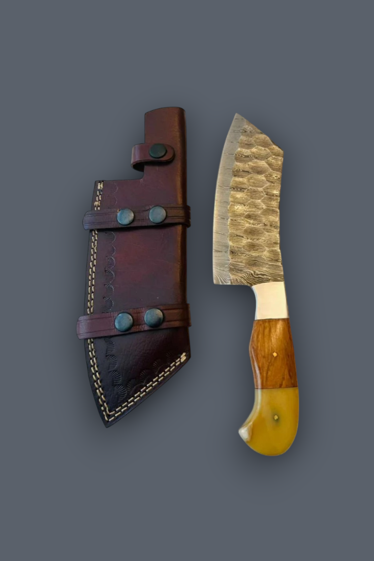 A fixed-blade knife with a hammered steel blade and a dual-tone wooden handle, displayed next to its dark brown leather sheath on a solid dark gray background.
