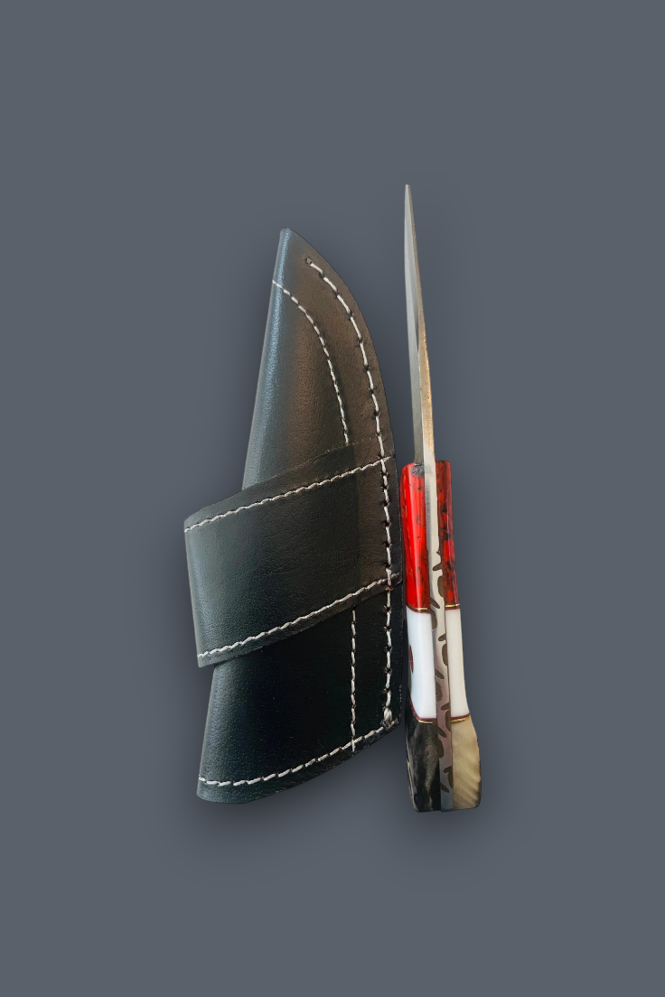 A small knife with a red handle and silver blade, shown next to a black leather sheath with white stitching, on a solid dark gray background.