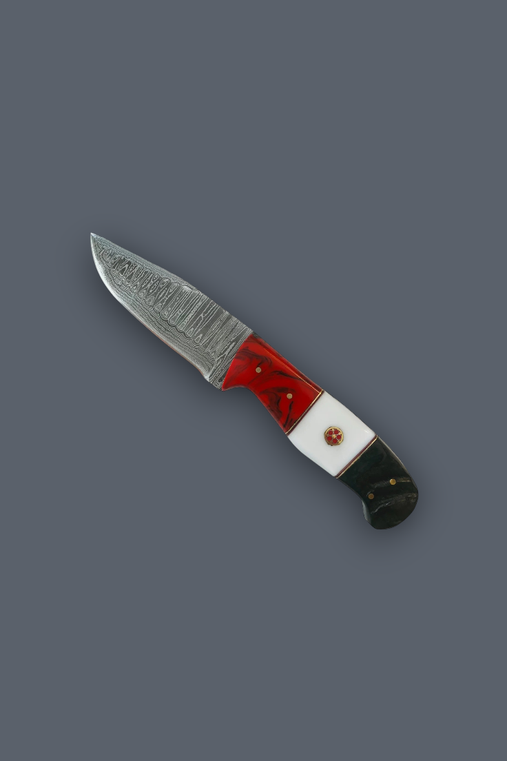 A small fixed-blade knife with a patterned steel blade, a red and white handle, and a black end, shown on a solid dark gray background.