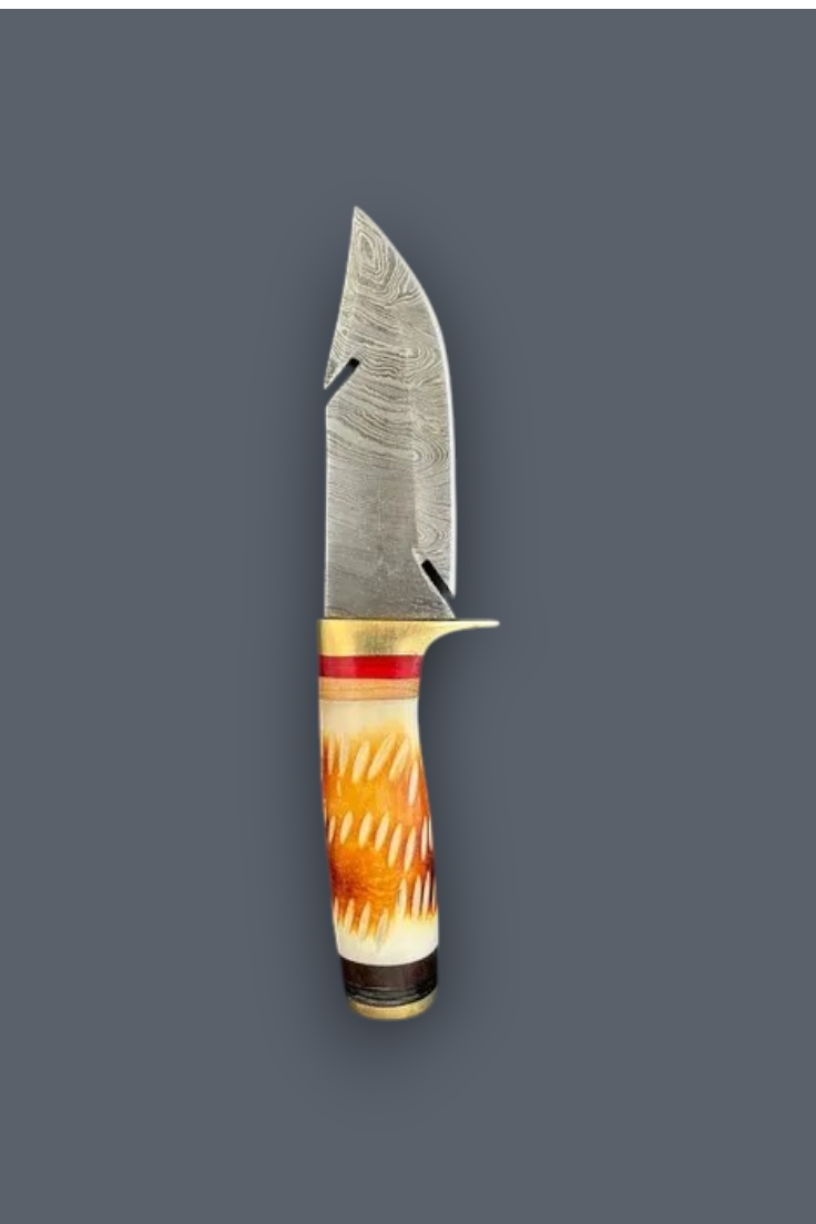 A custom fixed-blade knife with a Damascus steel blade, a brass bolster, and a decorative handle made of orange and white patterned bone or horn, set against a solid dark gray background.
