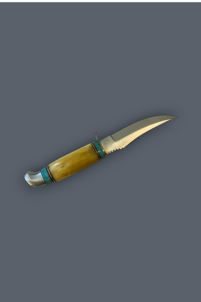A fixed-blade knife with a curved yellow-brown handle, turquoise-colored inlay bands, and a silver-colored metal blade, shown against a solid dark gray background.