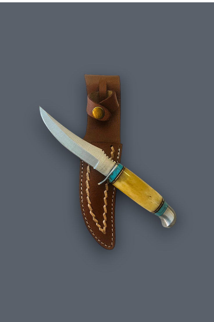 A fixed-blade knife with a silver blade, a yellow bone handle, and turquoise accents, shown partially inserted into a brown leather sheath against a solid dark gray background.