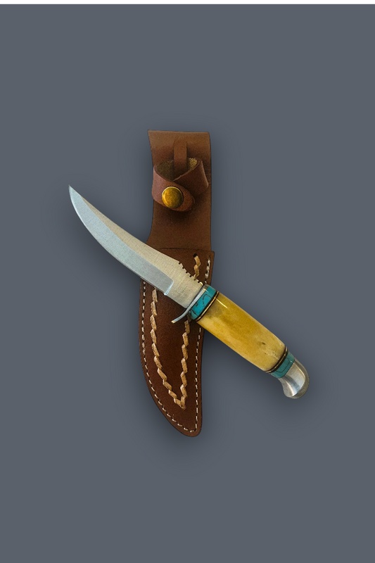 A fixed-blade knife with a silver blade, a yellow bone handle, and turquoise accents, shown partially inserted into a brown leather sheath against a solid dark gray background.