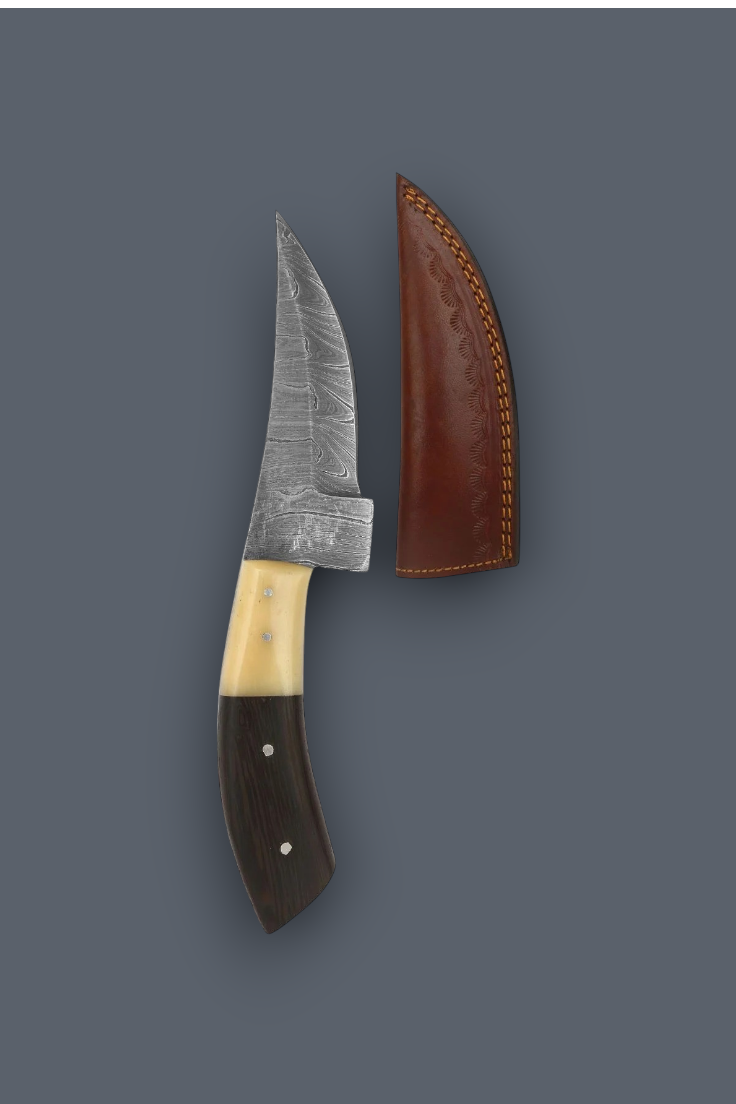 A fixed-blade knife with a patterned steel blade, a cream-colored middle section, and a dark brown handle, shown next to its brown leather sheath on a solid dark gray background.