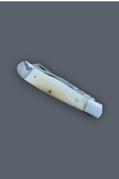 A classic folding pocket knife with a cream-colored bone handle and a silver metal blade, shown against a solid dark gray background.