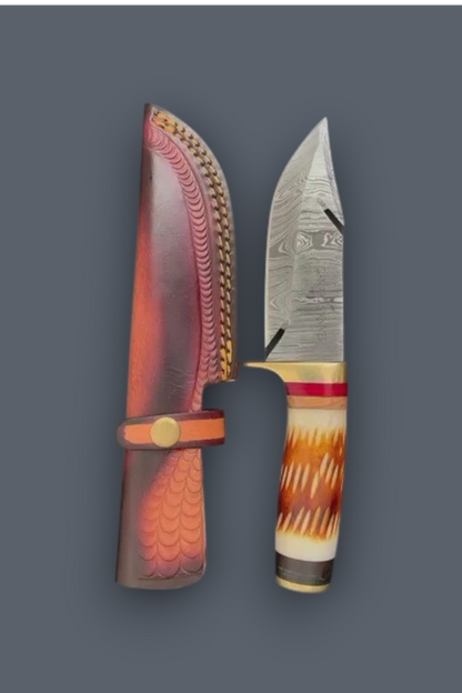 A fixed-blade knife with a patterned steel blade and a carved handle, shown next to its matching sheath on a solid dark gray background.