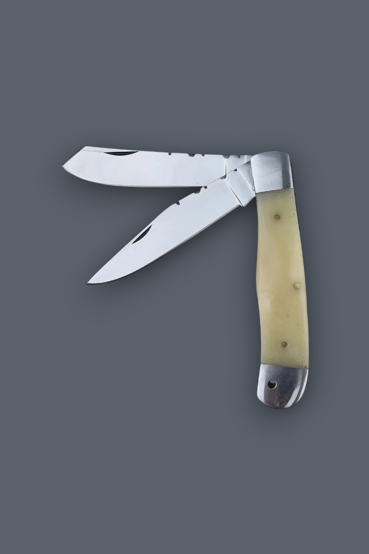 A classic folding pocket knife with two partially serrated stainless steel blades, featuring a cream-colored bone handle with silver-toned metal bolsters, set against a solid dark gray background.