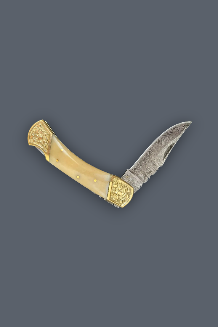 A folding pocket knife with a patterned steel blade, an ivory-colored bone handle, and ornate gold-toned metal fittings, shown against a solid dark gray background.