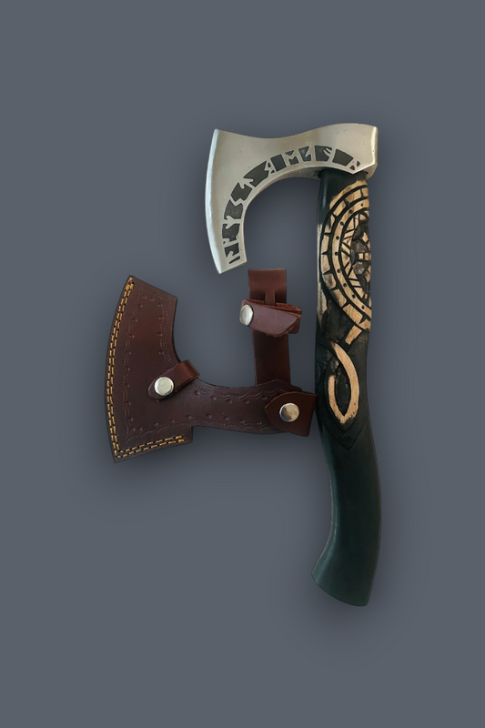 A decorative Viking-style axe with a curved silver blade, dark green handle featuring gold Norse knotwork carvings, and a brown leather sheath, displayed on a solid dark gray background.