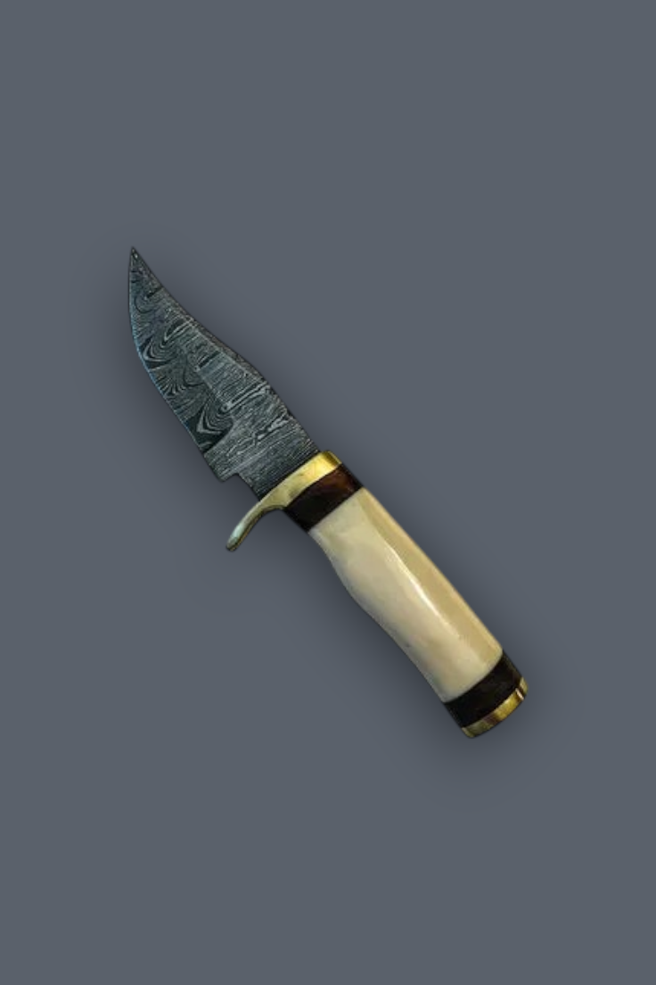 A fixed-blade knife with a patterned steel blade, a cream-colored bone handle, and brass and black accents, shown on a solid dark gray background.