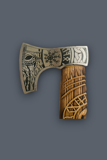 A hand-carved Viking-style axe with a silver-toned metal head featuring Norse runes and animal engravings, and a brown wooden handle with geometric patterns, shown against a solid dark gray background.