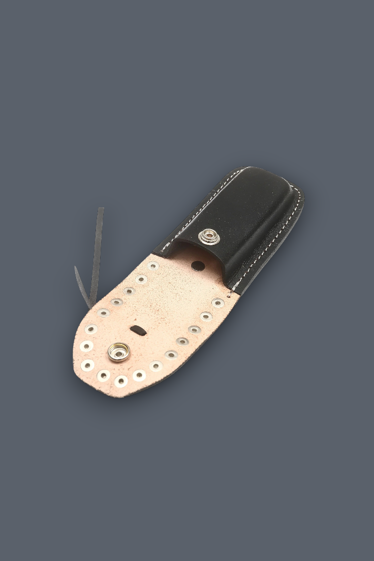 A leather knife sheath with a black leather body, a light tan leather flap, and silver metal rivets and hardware, shown on a solid dark gray background.